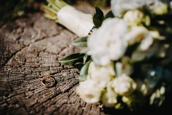 Two wedding rings on the floor with contrast wedding rings on floor, on ground, on piano, in hand