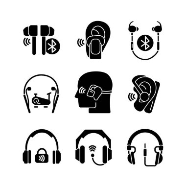 Kulaklıklar beyaz alana siyah kabartma simgeler yerleştirilmiş. Müzik uzmanlığı için profesyonel kulaklıklar. Spor aktiviteleri için kulaklık. Kablolu, kablosuz cihaz. Siluet sembolleri. Vektör izole illüstrasyonu