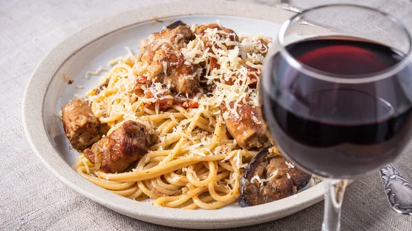 Spaghetti Sausage Eggplant Sauce Grated Cheese Table Glass Red Wine — Stock fotografie