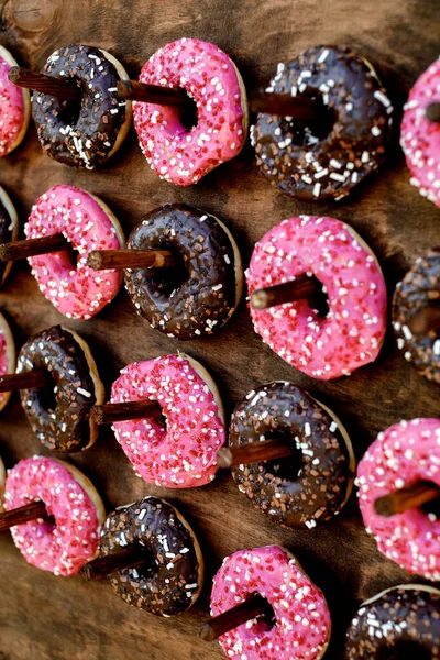 Pink and chocolate donuts. Holiday snacks.