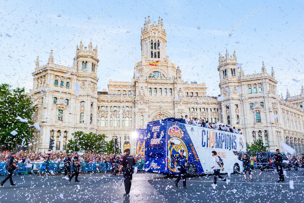 Madrid, Spain- May 29, 2022: Real Madrid C.F celebrates its 14th European Championship in Madrid. The team bus circulates towards the post office building in Plaza de Cibeles escorted by the national police