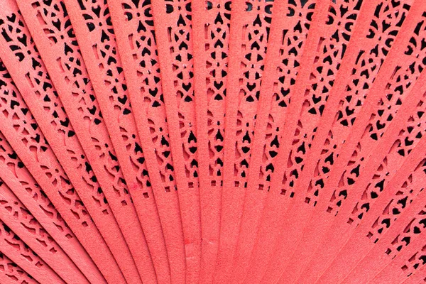 Red fan with details in the wood and thread tassel attached to the handle. Andalusian fan. Spanish costume accessory. Color fans.