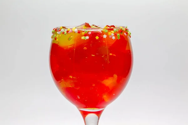 Fruit jelly cocktail. Glass cup filled with strawberry jelly and rims of stars with sugar. Gelatin mix. Sugary drinks. Cool drinks.