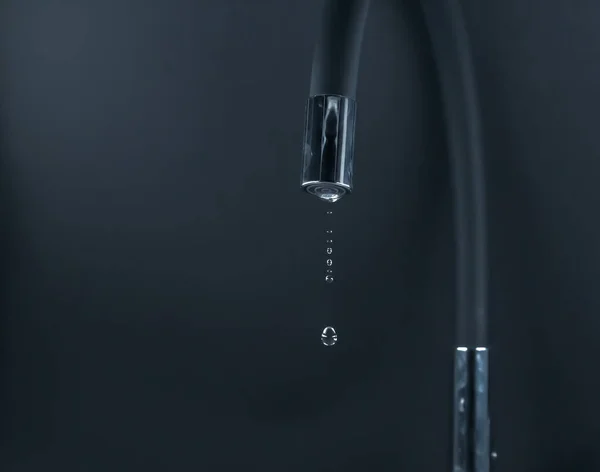 water drought. water restrictions. Drops of water falling from the faucet. Faucet items. water cuts. Restrictions on water consumption during the summer.