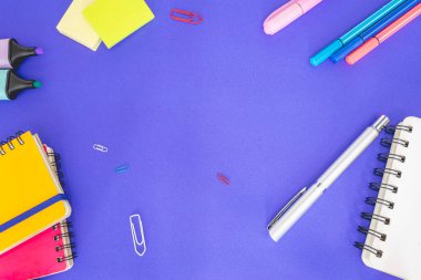 Flatlay from office and school stuff on a colour background.
