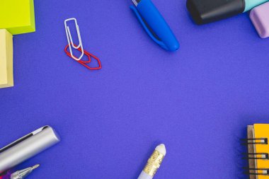 Flatlay from office and school stuff on a colour background.