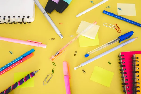 Flatlay from office and school stuff on a colour background.