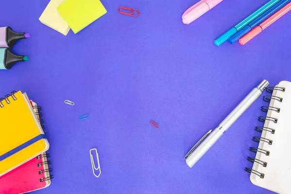 Flatlay from office and school stuff on a colour background.