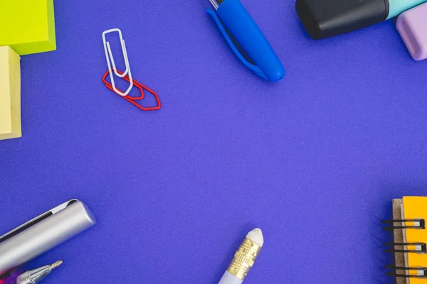 Flatlay from office and school stuff on a colour background.
