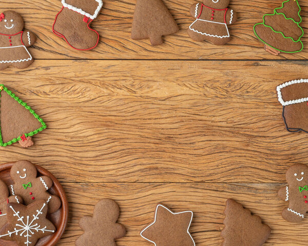 Traditional christmas gingerbread cookies over a wooden table with copy space.