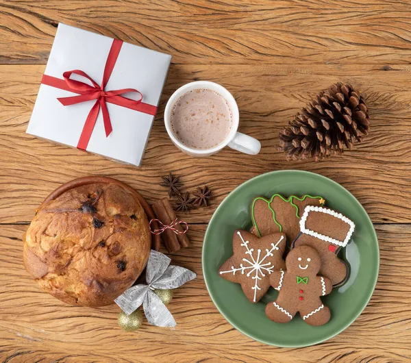 Traditional italian christmas fruit cake panettone with gingerbread cookies, hot chocolate, gift box and christmas decoration