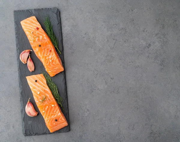 Baharatlı çiğ somon dilimleri. Taş tahtada fotokopi alanı ile birlikte..