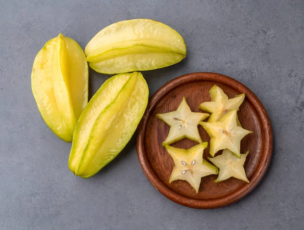 Starfruits Slices Plate Stone Background — Zdjęcie stockowe