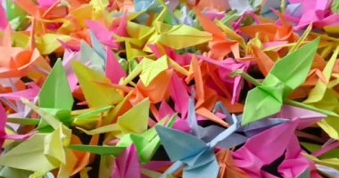 A group of colorful tsuru origamis. Japanese thousand tsurus legend.