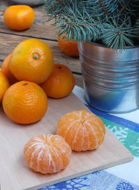 Soyulmuş ve soyulmamış mandalinalar, narenciye meyveleri, şenlikli kompozisyon, yeni yıl, noel