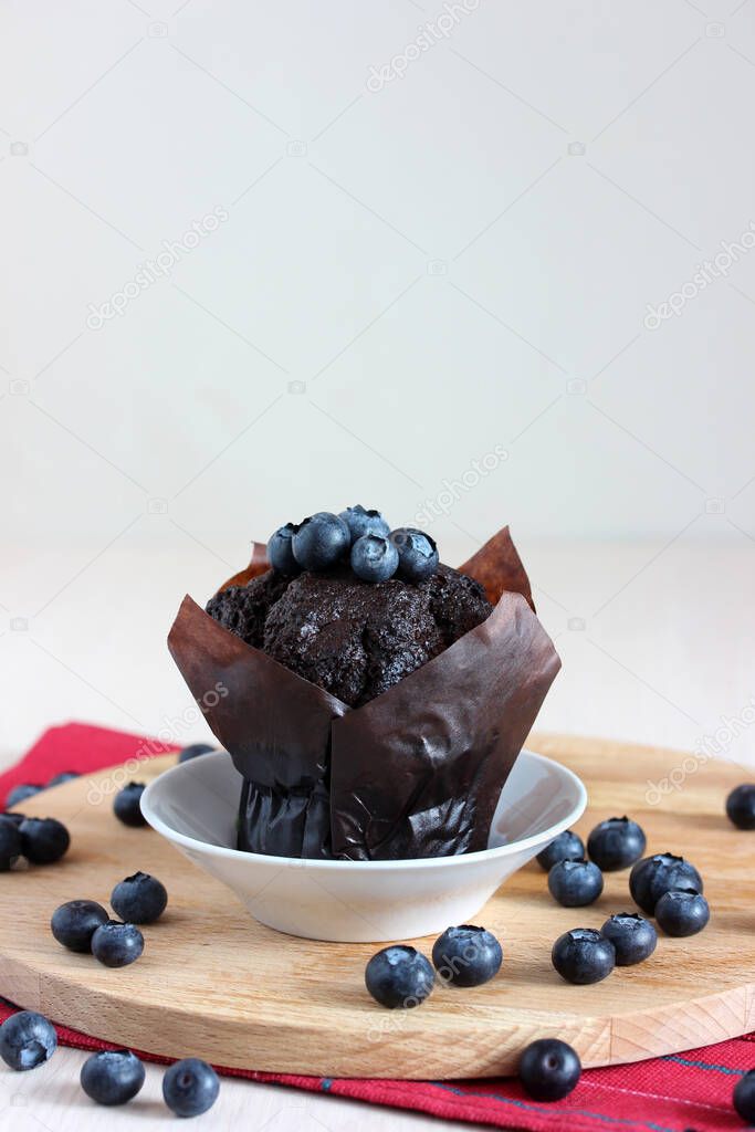 chocolate muffin and blueberries. sweet dessert, treat. cake and berries.