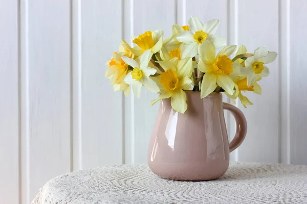 Kytice Žlutých Narcisů Džbánu Stole Krajkovým Ubrusem Jarní Skladba Květinami — Stock fotografie