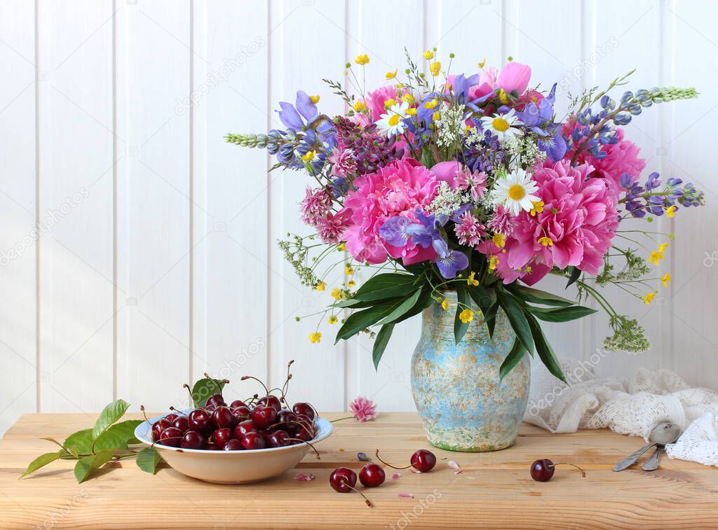 lush summer bouquet of peonies, irises, buttercups and daisies.