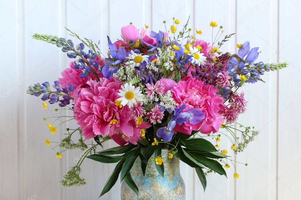 bright bouquet of peonies, buttercups, lupines