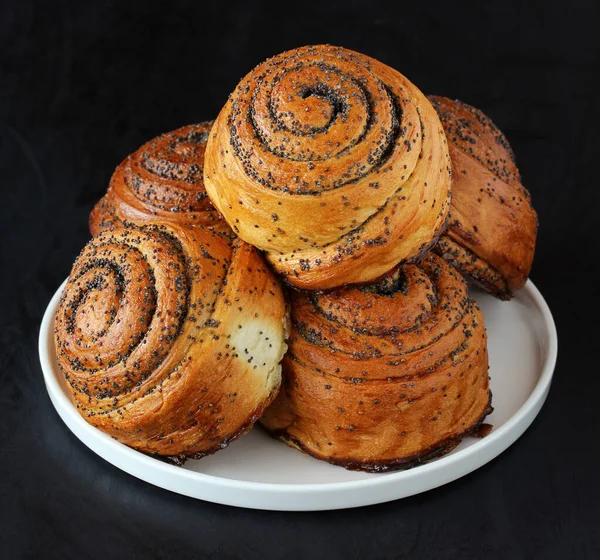 Bunch of sweet twisted buns with poppy seeds. Stock Image