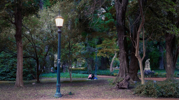 People enjoying a warm autumn afternoon in Carlos Thays botanical garden               