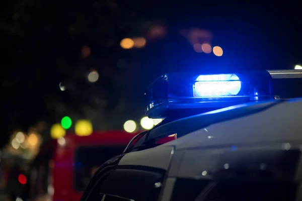 Emergency light of police patrolling car on street in night