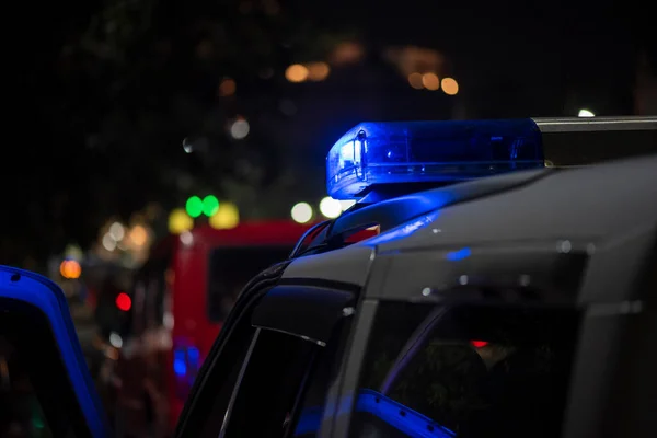 Emergency light of police patrolling car on street in night