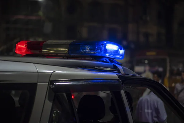 Emergency light of police patrolling car on street in night