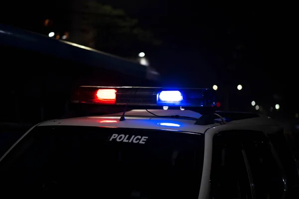 Emergency light of police patrolling car on street in night