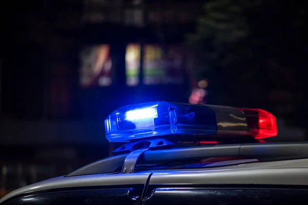 Emergency light of police patrolling car on street in night