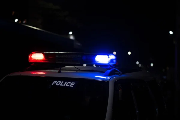 Emergency light of police patrolling car on street in night