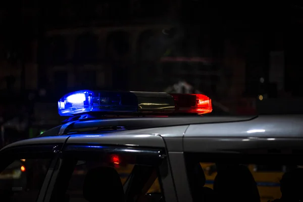 Emergency light of police patrolling car on street in night