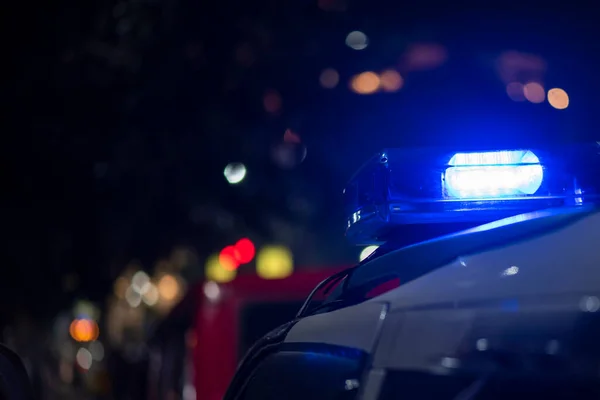 Emergency light of police patrolling car on street in night