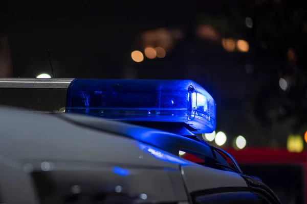 Emergency light of police patrolling car on street in night