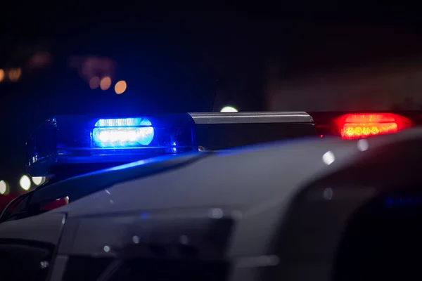 Emergency light of police patrolling car on street in night