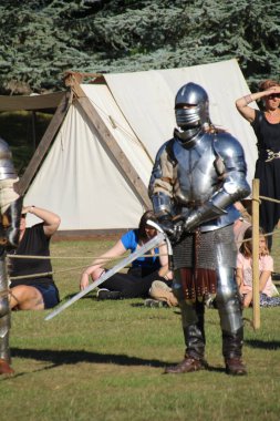 Hever, UK - 29 August, 2022: Re-enactment of medieval knights in armour on an ancient battlefield.
