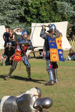 Hever, UK - 29 August, 2022: Re-enactment of medieval knights in armour on an ancient battlefield.