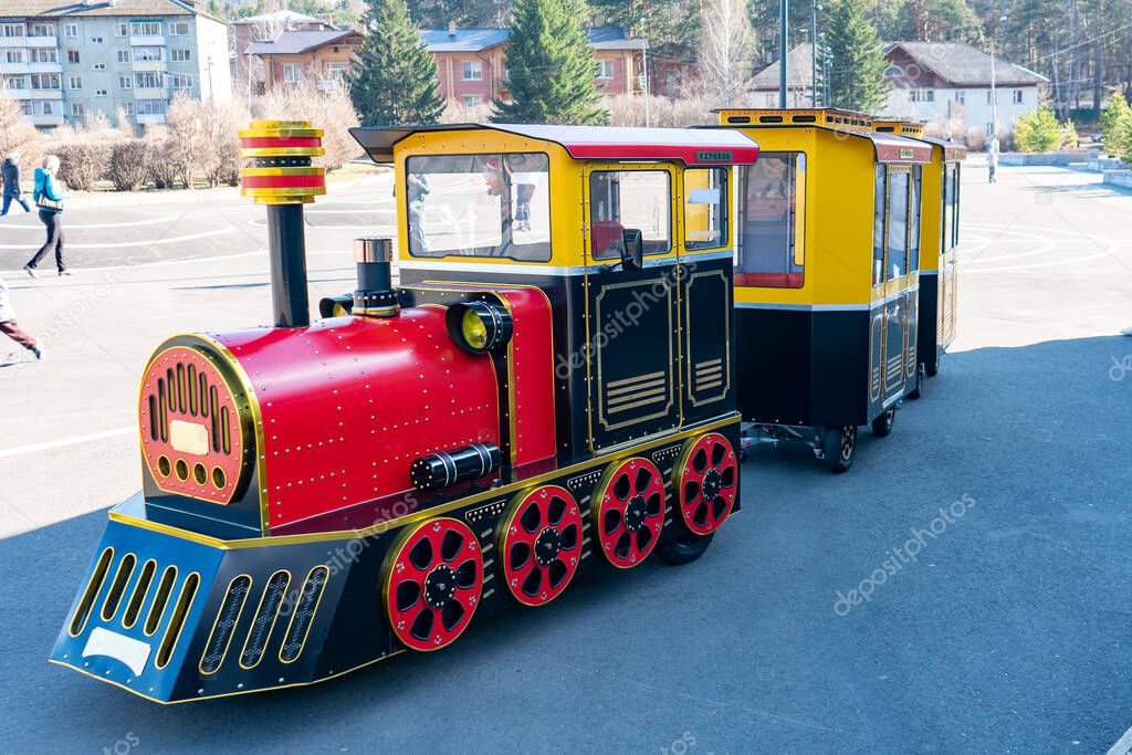 Red steam locomotive for children to walk on the playground.