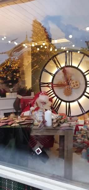 수직 영상입니다. 분주한 산타클로스는 노트를 쓰고 밤에일 하면서 창밖을 내다본다. 성 니콜라스가 아이들의 소원 과 선물 목록을 만들고 있습니다.. — 비디오