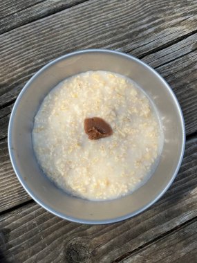 Bowl of plain porridge topped with umeboshi plum paste