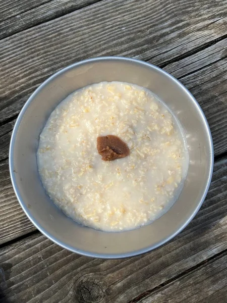Bowl of plain porridge topped with umeboshi plum paste