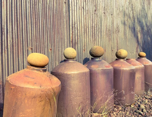 Row of vintage stoneware Japanese shochu bottles
