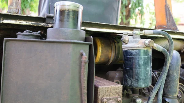 Close-up view of dirty oil filter. Old excavator engine black metal oil filter with copy space. selective focus