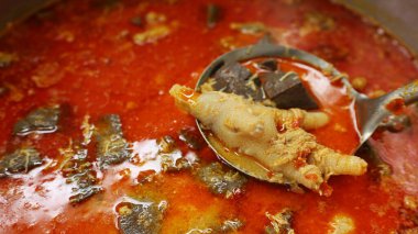 Kırmızı körili tavuk ayağı. Baharatlı Tayland baharatlı kırmızı köri, kırmızı köri soslu vermicelli ile yenir. Yakın çekim odağı