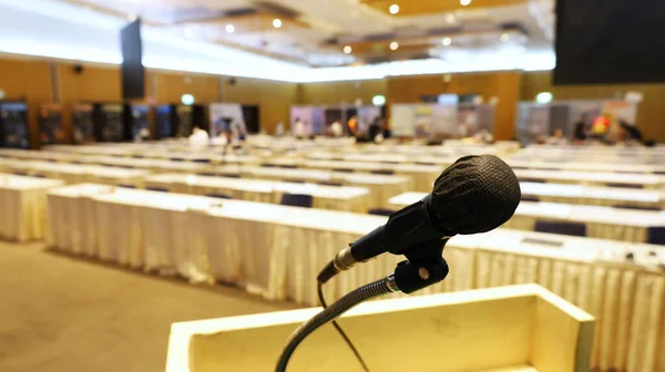 Microphones in front of the meeting room. A microphone wrapped in black cloth sits on a podium in the seminar room with a copy space. Selective focus