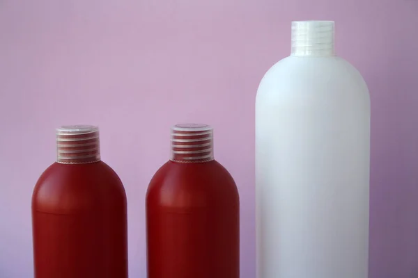 Red Cosmetic Shampoo Bottles Pink Background — Stock Photo, Image