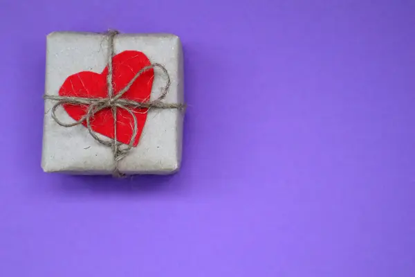紫色の背景に赤いハートとクラフトリボンとクラフトギフトボックス お祝いだ バレンタインデーの概念 トップ表示 — ストック写真