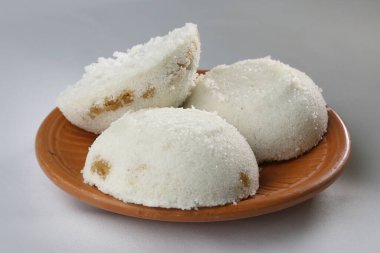 Steamed Rice Cake or Bhapa Pitha is a traditional dish of Bangladesh. Winter Vapa Pitha snacks on clay plate.