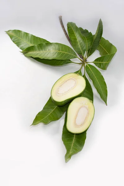 slices of raw green mango on leaves.
