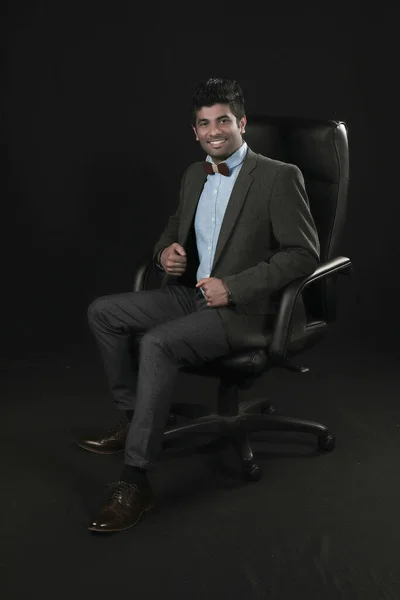 Portrait Young Businessman Sitting Chair Looking Camera Isolated Black Background – stockfoto